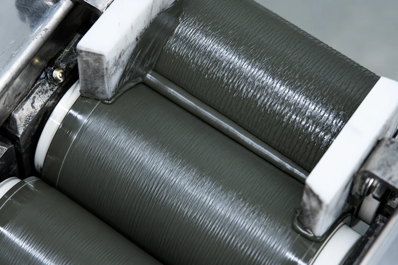 Dark carbon-film material processed between textured metal rollers